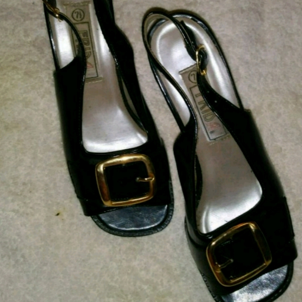 Black womens dress shoes w/gold buckle over toes.